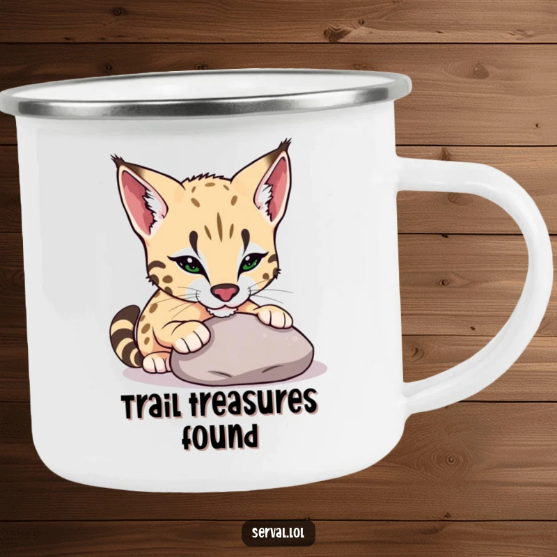Funny serval camping mug showing a serval playfully nudging a smooth pebble with its nose, perfect for outdoor moments of curiosity.