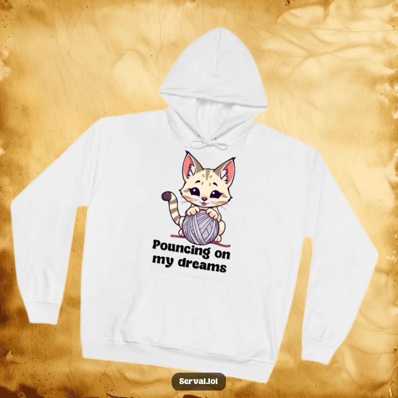 Funny serval hoodie, a wild cat energetically pouncing on a ball of yarn, offering cozy comfort and humor.