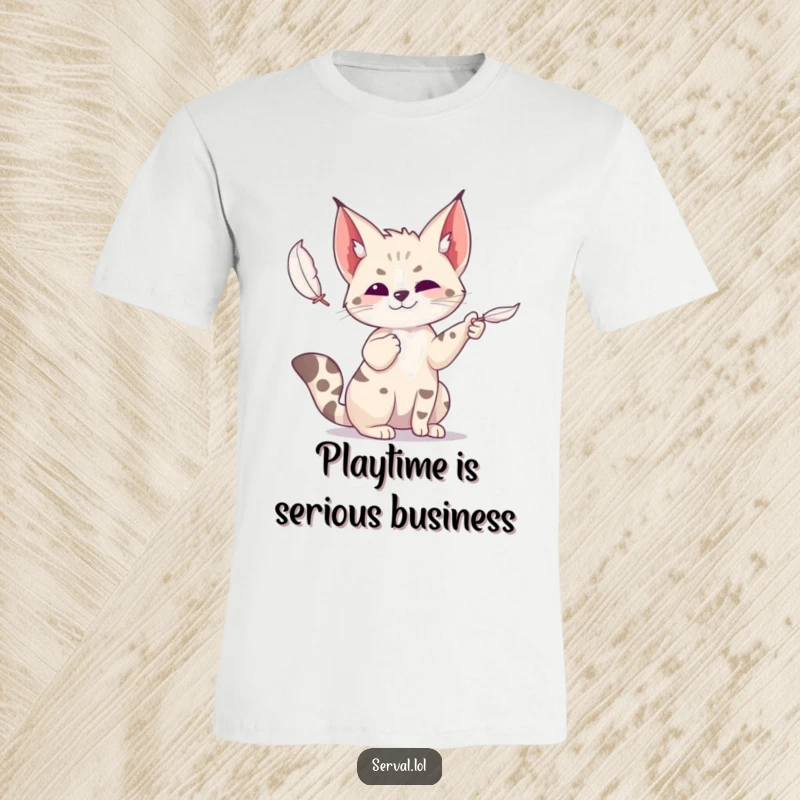 Funny serval t-shirt depicting a wild cat joyfully batting at a suspended feather, showcasing its energetic and playful nature.