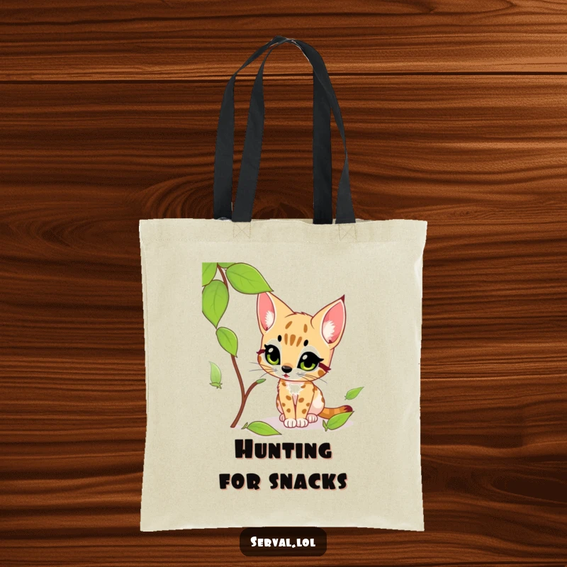Funny serval tote bag showcasing a serval's intense gaze as it curiously stalks a rustling leaf with predatory excitement.