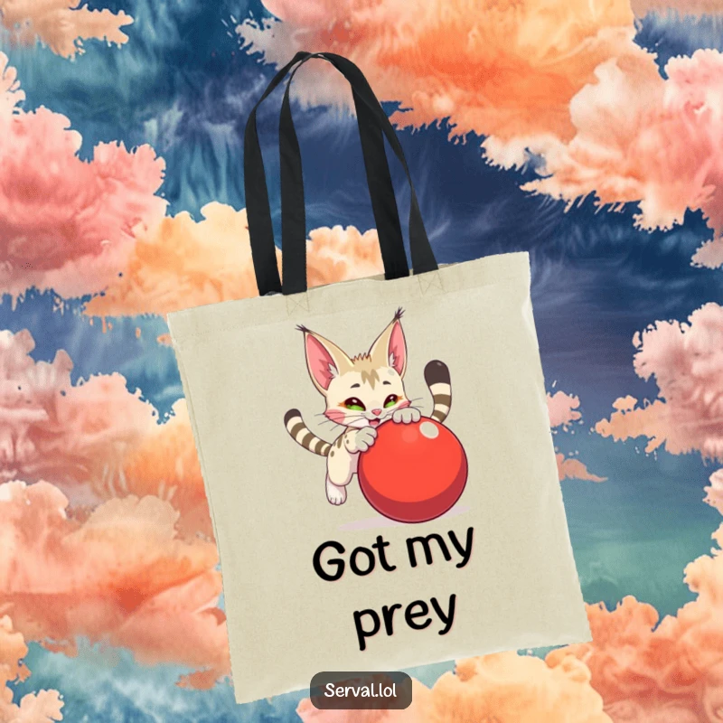 Funny serval character tote bag, actively pouncing on a large red ball, embodying fierce, yet adorable, playful intent.