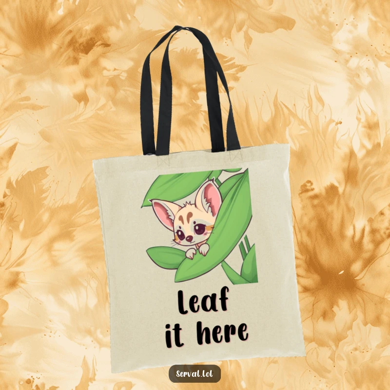 Funny serval tote bag with a serval peeking from behind a large jungle leaf, adding a touch of mystery.
